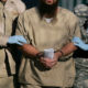 ဂွာတီနာမို အကျဉ်းထောင်မှ အကျဉ်းသား တစ်ဦးအား အကျဉ်းထောင် လုံခြုံရေးဝန်ထမ်း နှစ်ဦးက ခေါ်ဆောင်လာစဉ် (ဓာတ်ပုံ- အင်တာနက်)