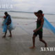 ရခိုင်ပြည်နယ် ပင်လယ်ကမ်းခြေတွင် ရေလုပ်သားနှစ်ဦးကို တွေ့ရစဉ် (ဆင်ဟွာ)