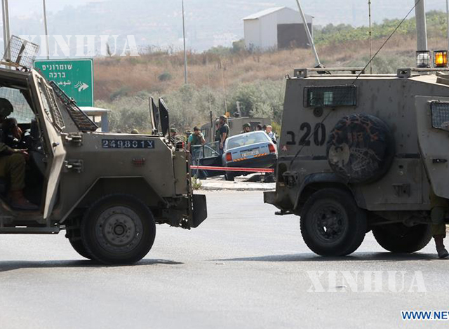 ပါလက်စတိုင်းနိုင်ငံသား အား အစ္စရေး စစ်သားများက ပစ်သတ်ခဲ့သည့် အခင်းဖြစ်ပွားရာသို့ လုံခြုံရေး တပ်ဖွဲ့ဝင်များရောက်ရှိလာစဉ် (ဆင်ဟွာ)