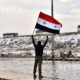 ဆီးရီးယား အလံ ေဝွ႔ယမ္းေနသည့္ အမ်ိဳးသား တစ္ဦးအား ေတြ႕ရစဥ္ (ဆင္ဟြာ)