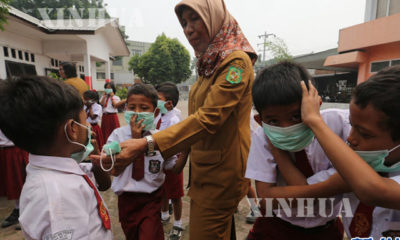 အင်ဒိုနီးရှားနိုင်ငံ ၊ မူလတန်းကျောင်းသားများက မျက်နှာဖုံးများ တပ်ဆင်၍ စာသင်နေမှု အား တွေ့ ရစဉ် (ဆင်ဟွာ)