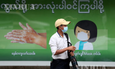 ရန်ကုန်မြို့ရှိ ဘတ်စ်ကားမှတ်တိုင် တစ်ခုတွင် နှာခေါင်းစည်း တပ်ဆင်ထားသူ တစ်ဦးအား တွေ့ရစဉ်(ဆင်ဟွာ)
