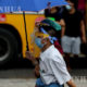 ရန်ကုန်မြို့၌ နှာခေါင်းစည်း ၊ မျက်နှာဖုံး အကာအကွယ်များဖြင့် သွားလာနေသူများအား တွေ့ရစဉ်(ဆင်ဟွာ)