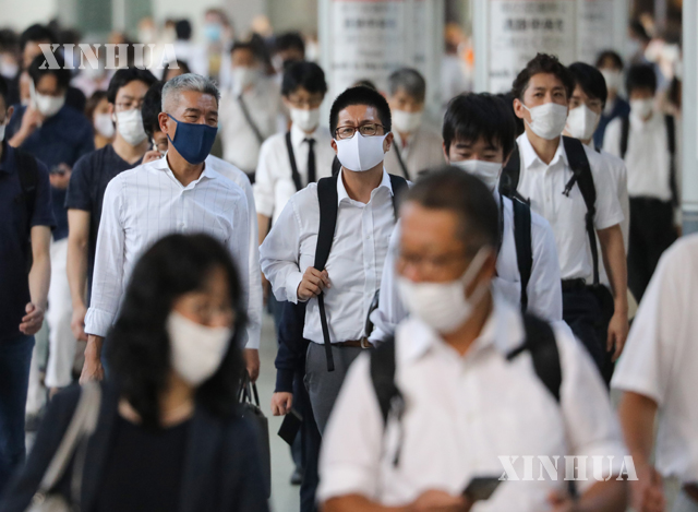 ဂျပန်နိုင်ငံ တိုကျိုမြို့တွင် လူများ နှာခေါင်းစည်းတပ်၍ သွားလာလှုပ်ရှားနေသည် ကိုမြင်တွေ့ရစဉ်(ဆင်ဟွာ)