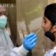 A medical worker collects a sample from a woman for COVID-19 test in Delhi, India on June 24, 2020. (Photo by Partha Sarkar/Xinhua)